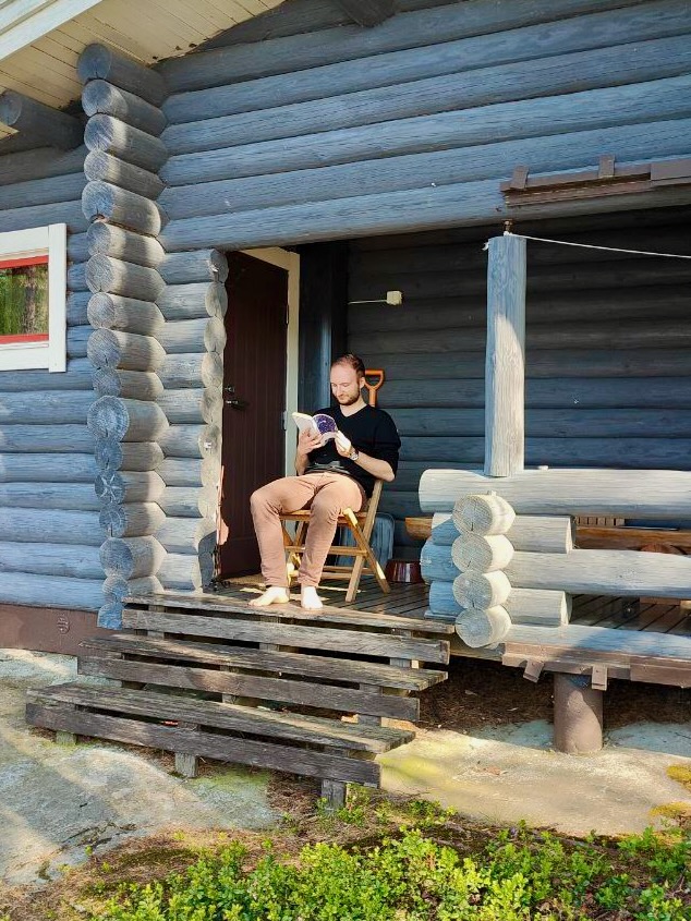 A picture of me reading at a Finnish cottage